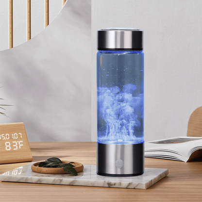 Stainless steel water bottle with blue LED light on a marble surface