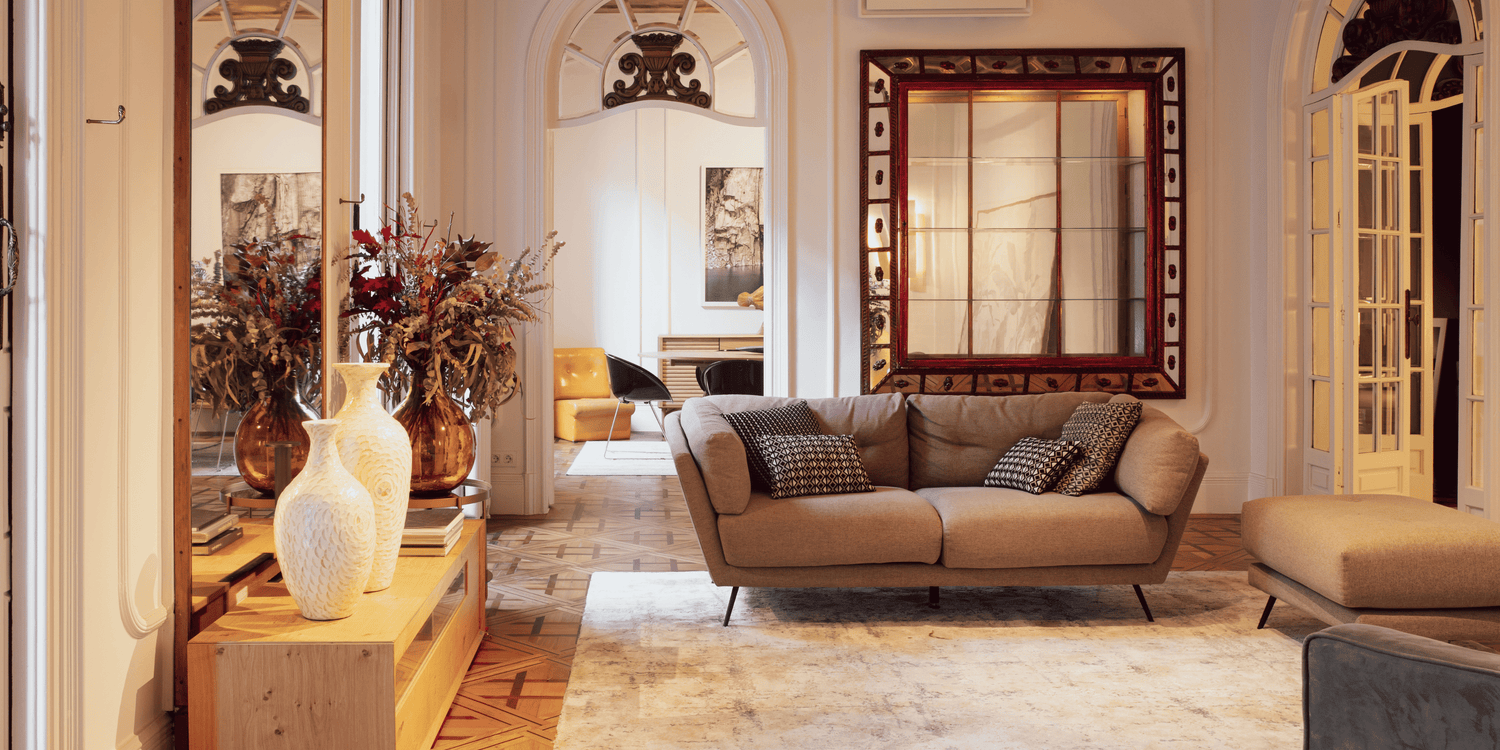 Living room with a beige sofa, wooden coffee table, and decorative mirrors.