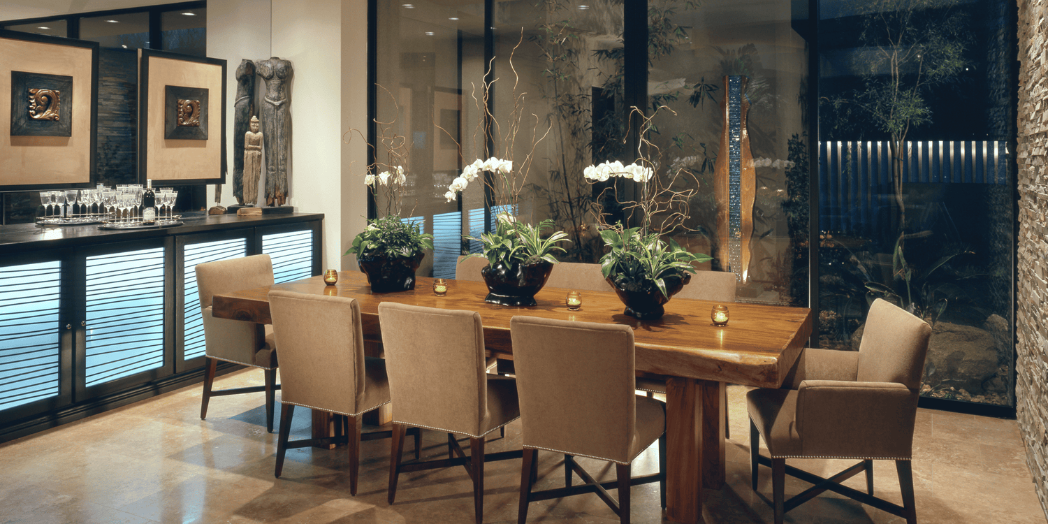 Dining room with a wooden table and chairs near a large window.